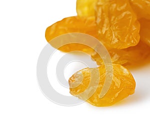 Yellow sultanas raisins close-up isolated on a white background.