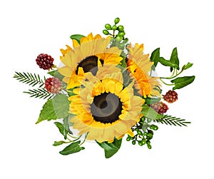 Yellow sunflowers, berries and green grass and leavesin a summer arrangement isolated