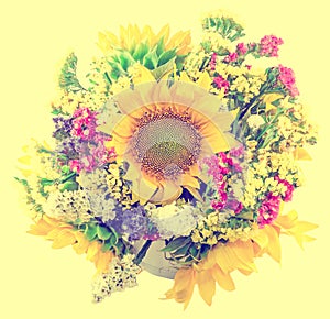 Yellow sunflowers and colored wild flowers in a white vase, close up