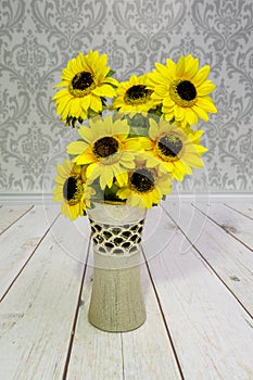 Yellow sunflowers, coloredartificial flowers in a decorative vase