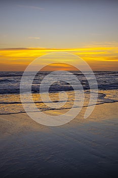 Yellow sunset on the beach. Seascape for background. Colorful sky. Beautiful water reflection. Sunlight on horizon line. Nature