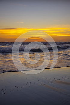 Yellow sunset on the beach. Seascape for background. Colorful sky. Beautiful water reflection. Sunlight on horizon line. Nature