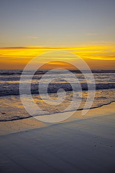 Yellow sunset on the beach. Seascape for background. Colorful sky. Beautiful water reflection. Sunlight on horizon line. Nature