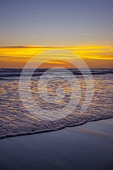 Yellow sunset on the beach. Seascape for background. Colorful sky. Beautiful water reflection. Sunlight on horizon line. Nature