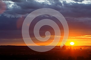 Yellow sunset over industrial landscape with factory chimneys and pipes with smoke polluting the atmosphere