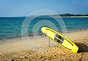 Yellow surf rescue surfboard on the beach