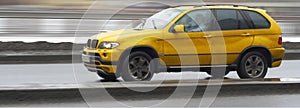 Yellow suv x5 luxury german car, driving fast