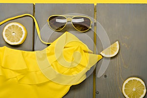 Yellow swimsuit one-piece, aviator sunglasses