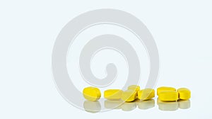 Yellow tablets pills isolated on white background with copy space for text. Ibuprofen tablets pills. Painkiller medicine