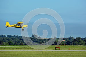 Yellow tail dragger airplane landing photo