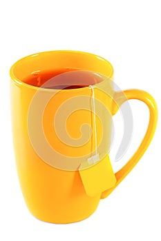 Yellow tall mug of tea with a label