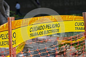 Yellow tape marked caution `cuidado` in Spanish
