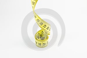 Yellow tape measure in meters and inches in a spiral
