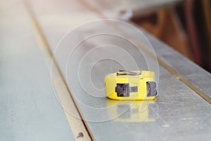 Yellow Tape Measurer on Sawing Machine. Close up. Copyspace.