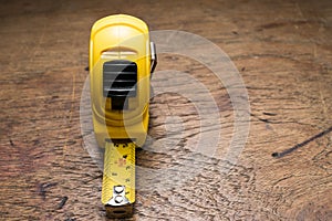 Yellow Tape ruler on wooden table