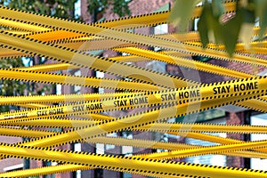 Yellow Tape With Stay Home Warning Sign At Business Centre. Quarantine. Social Distancing. Self Isolation. 3d rendering photo