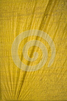 Yellow tarpaulin with folds