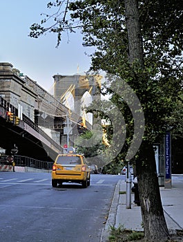 Yellow taxi cab approaches Brooklyn Bridge