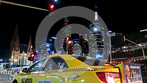 Yellow taxi cab in a street at night in Melbourne