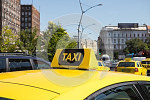 Yellow taxi car with a checker.