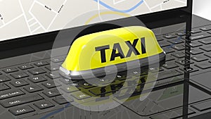 Yellow taxi car roof sign on black laptop