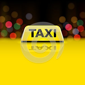 Yellow taxi car roof sign at night