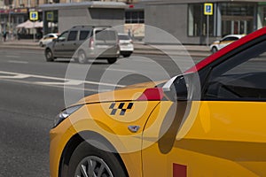 Yellow taxi with checker pattern, close-up view