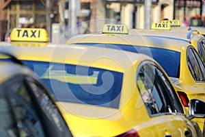 Yellow taxi in line on the street