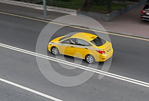 yellow taxi moves on the city