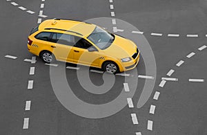 yellow taxi moves on the city street