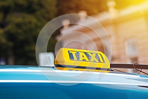 Yellow taxi sign on cab vehicle roof