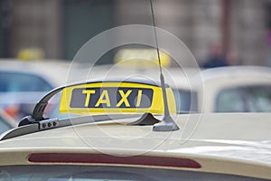 A yellow taxi sign on a taxi in the city