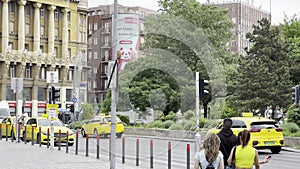 Yellow taxis are driving down the road to Anker house. Budapest, Hungary