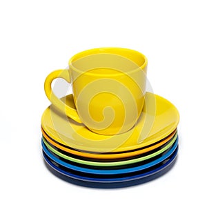 Yellow teacup and stack of saucer