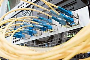 Yellow telecommunications cable in the server room of the data center. Concept of fast broadband access to the network. A bunch of