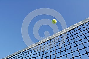 Yellow Tennis Ball Flying Over the Net