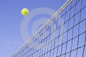 Yellow Tennis Ball Flying Over the Net