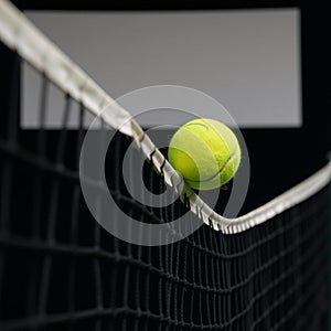 Yellow tennis ball soaring towards blackbackdrop tennis net banner for text insertion Generated by photo