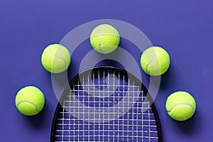 Yellow tennis balls and racket. Violet background. Concept sport.