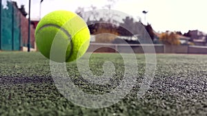 Yellow tennis balls in super slow motion 1000 fps on a clay green court next to the white line with copy space, soft