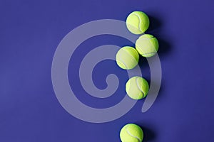 Yellow tennis balls on violet background. Concept sport.