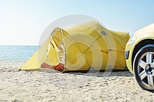 Yellow tent on the beach at bright sunny day