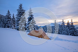 Yellow tent in the hoarfrost, standing on an alpine meadow