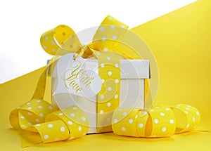 Yellow theme gift box with yellow polka dot ribbon and white copy space