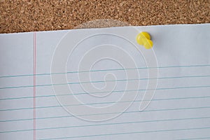Yellow Thumb Tack Holding Paper on Cork Board