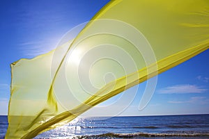 Yellow tissue flying over the sea