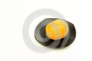 Yellow tomato on black squire plate