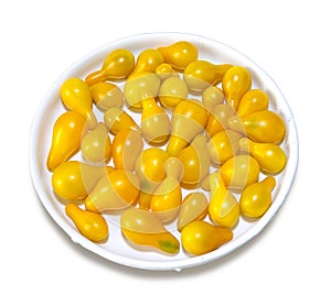 Yellow tomato on the plate