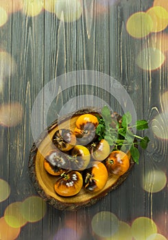Yellow tomatoes Siberian tiger on an old wooden table