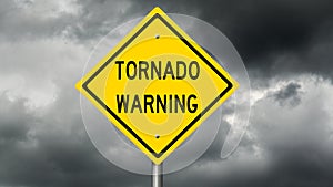 Yellow tornado warning sign and dark clouds